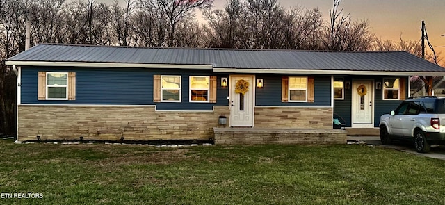 view of front of home with a lawn