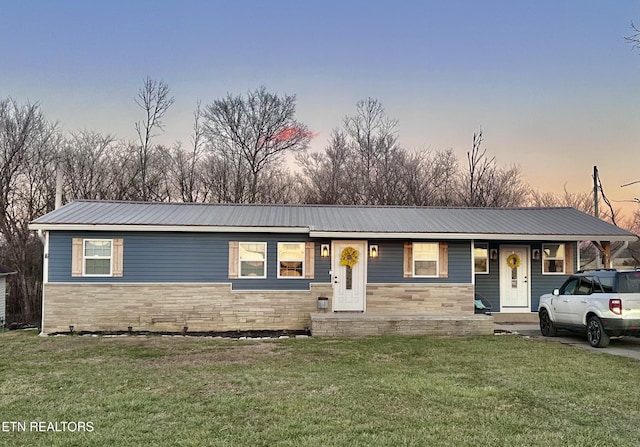 ranch-style house with a lawn