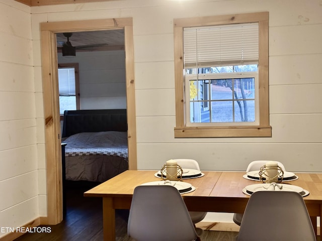 unfurnished dining area with dark wood-style flooring