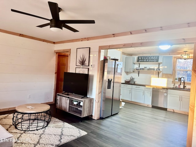 living room with ceiling fan, wood-type flooring, and sink