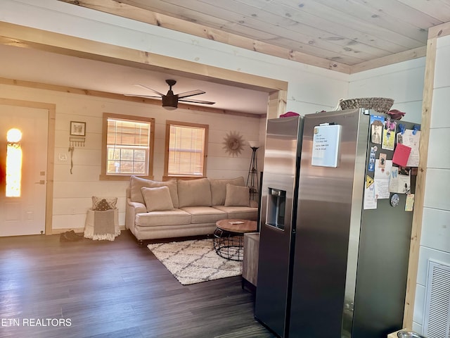 kitchen with stainless steel fridge, wooden walls, wooden ceiling, ceiling fan, and dark wood-type flooring