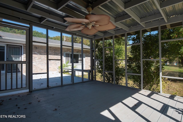 unfurnished sunroom featuring ceiling fan