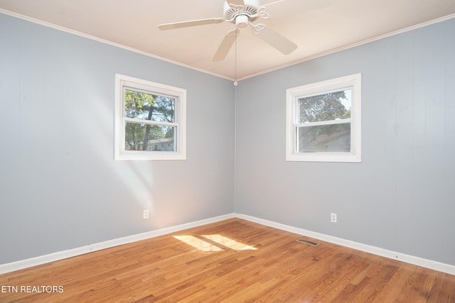 spare room with ceiling fan, crown molding, and hardwood / wood-style floors