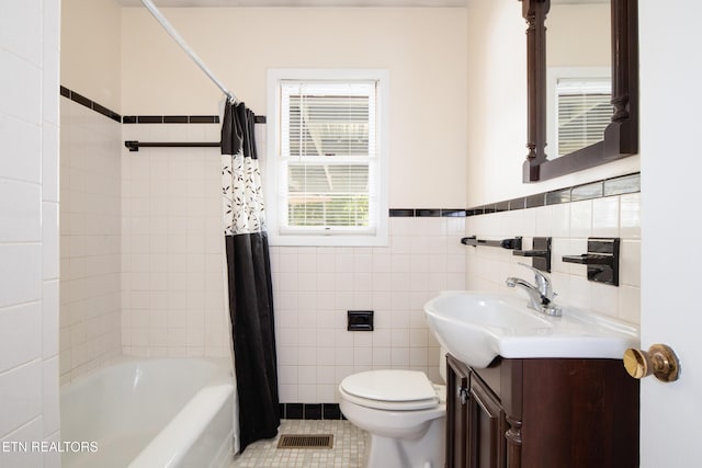 full bathroom featuring toilet, tile walls, tile patterned floors, shower / bath combination with curtain, and vanity