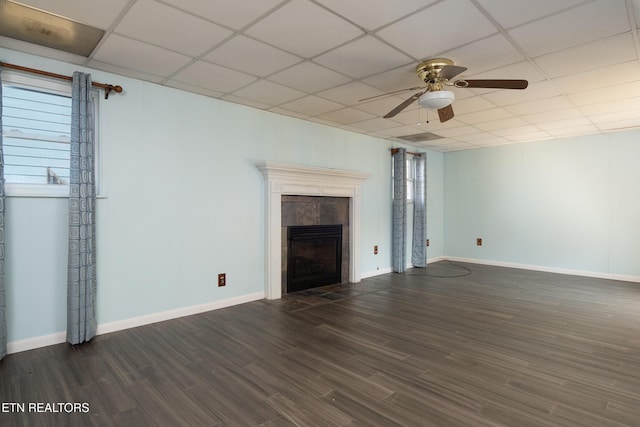 unfurnished living room with a fireplace, a paneled ceiling, ceiling fan, and dark wood-type flooring