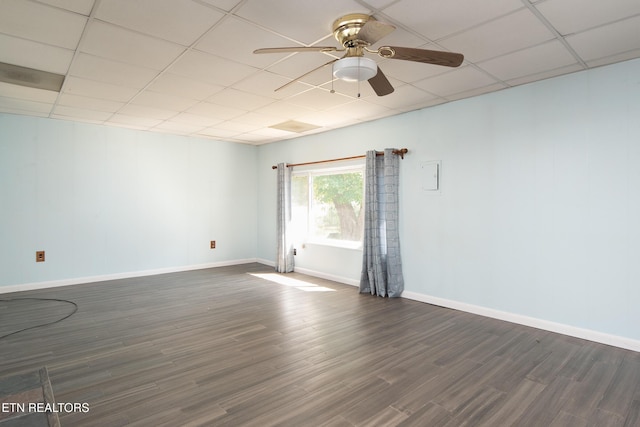 spare room featuring ceiling fan, dark hardwood / wood-style floors, and a paneled ceiling