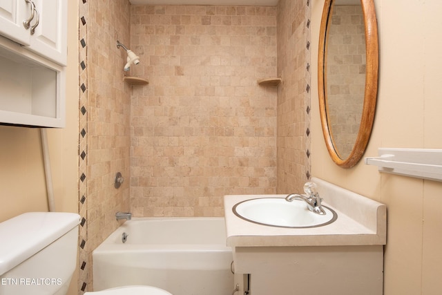 full bathroom featuring toilet, vanity, and tiled shower / bath