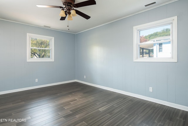 spare room featuring ceiling fan, dark wood-type flooring, and ornamental molding