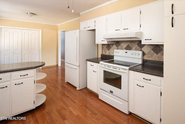 kitchen with white cabinetry, tasteful backsplash, white appliances, wood-type flooring, and ornamental molding