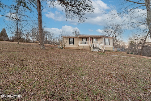 view of front of home with covered porch and a front yard