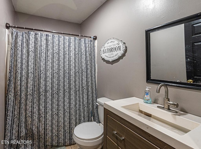 bathroom featuring toilet and vanity