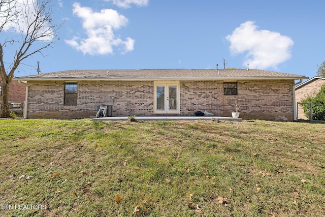 back of house with a lawn and french doors