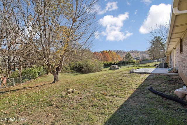 view of yard featuring a mountain view and a patio area