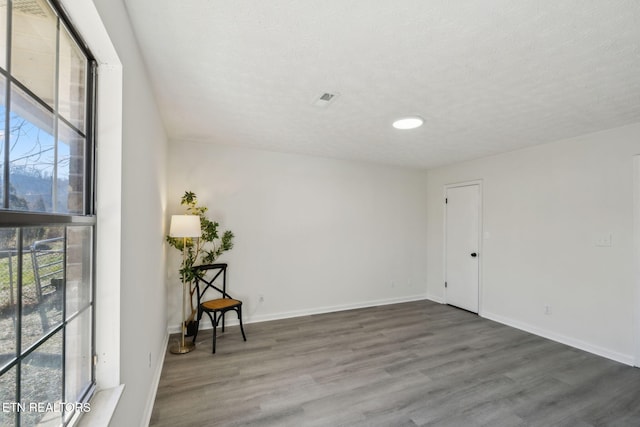 spare room with dark wood-type flooring