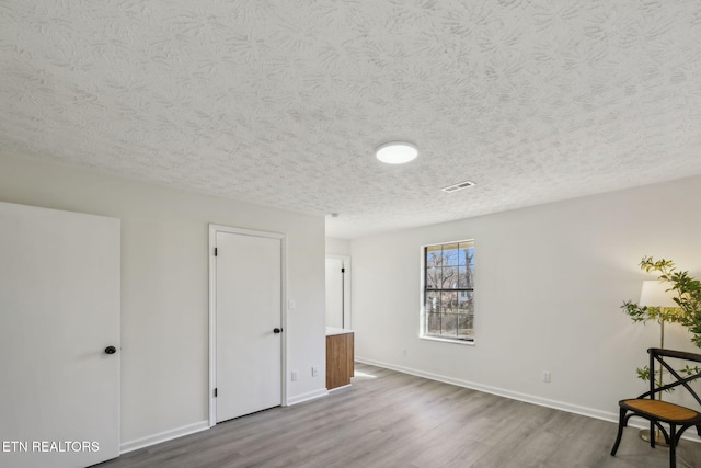 spare room with wood-type flooring