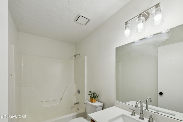 full bathroom featuring shower / tub combination, vanity, a textured ceiling, and toilet