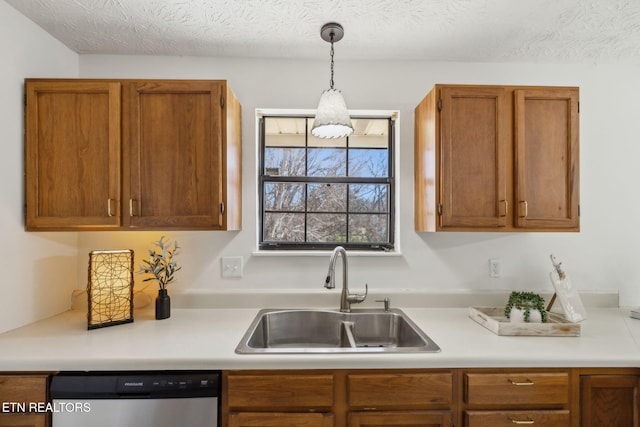 kitchen with sink, decorative light fixtures, a textured ceiling, and dishwasher