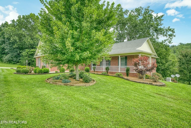 view of front facade with covered porch and a front yard