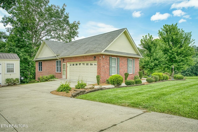 view of front of property with a front lawn and a garage