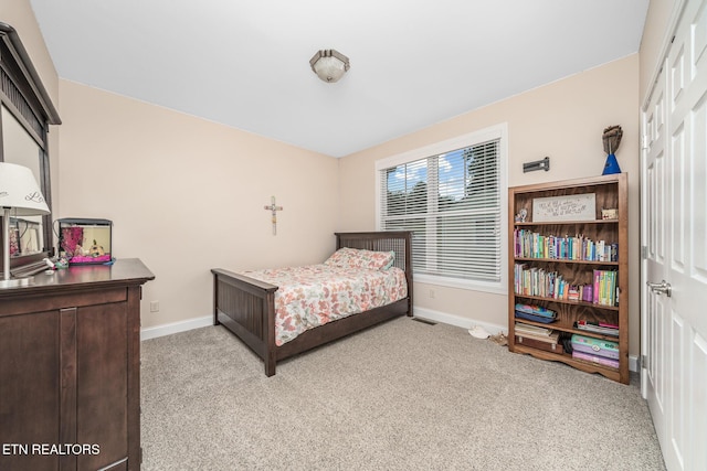 bedroom featuring light colored carpet