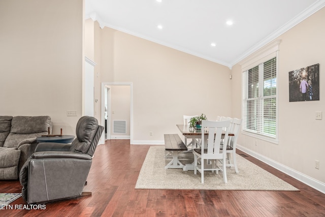 dining space featuring lofted ceiling, dark wood-type flooring, and ornamental molding