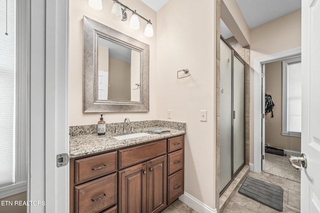 bathroom featuring an enclosed shower and vanity