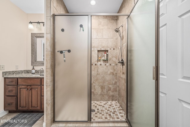 bathroom featuring an enclosed shower and vanity