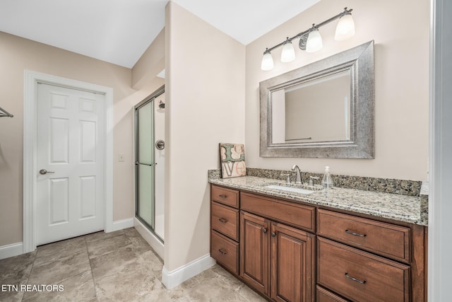 bathroom with an enclosed shower and vanity