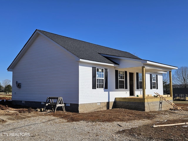 view of side of home featuring a porch