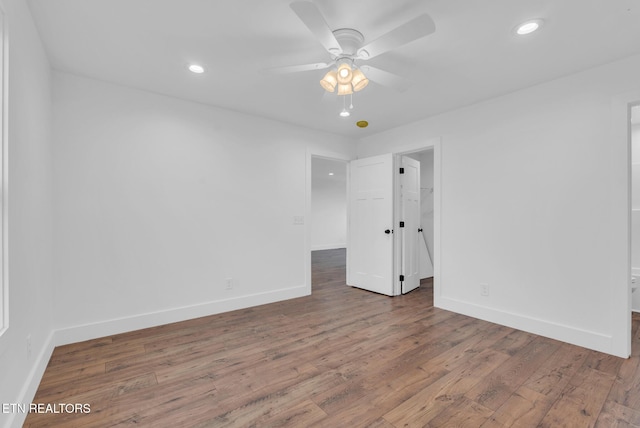 unfurnished room with wood finished floors, baseboards, recessed lighting, and a ceiling fan