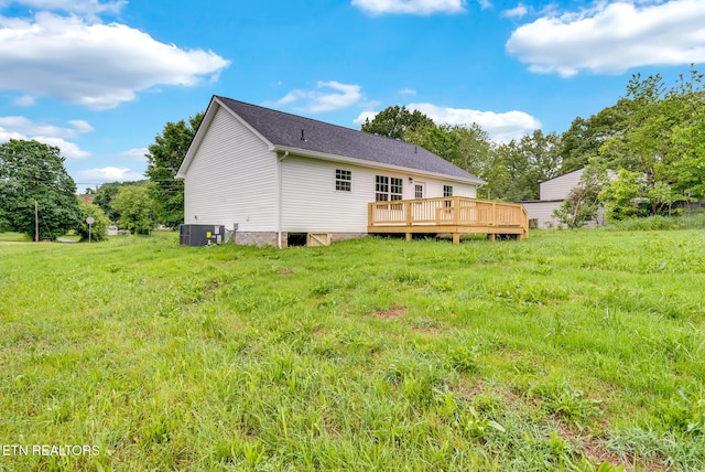 back of house featuring a deck, central AC, and a shingled roof