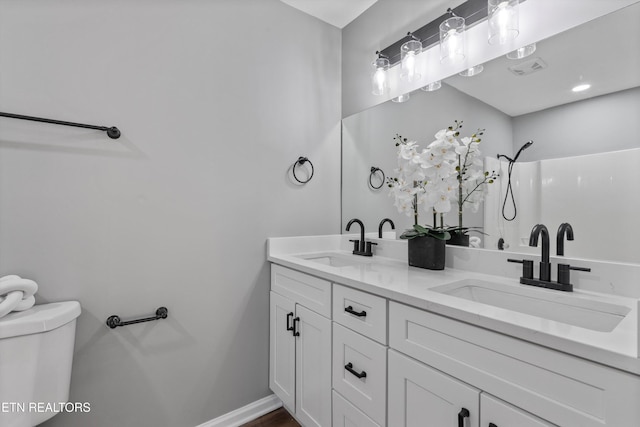 bathroom featuring toilet and vanity