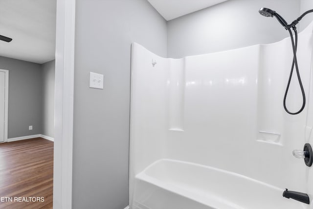 bathroom featuring shower / washtub combination and hardwood / wood-style floors