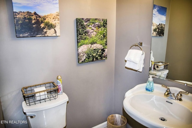 bathroom featuring toilet and sink