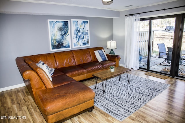 living room with crown molding and hardwood / wood-style floors