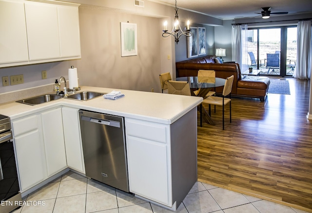 kitchen with white cabinets, light tile patterned floors, appliances with stainless steel finishes, and sink