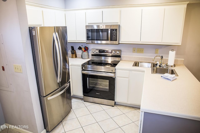 kitchen featuring sink, white cabinetry, stainless steel appliances, and light tile patterned flooring