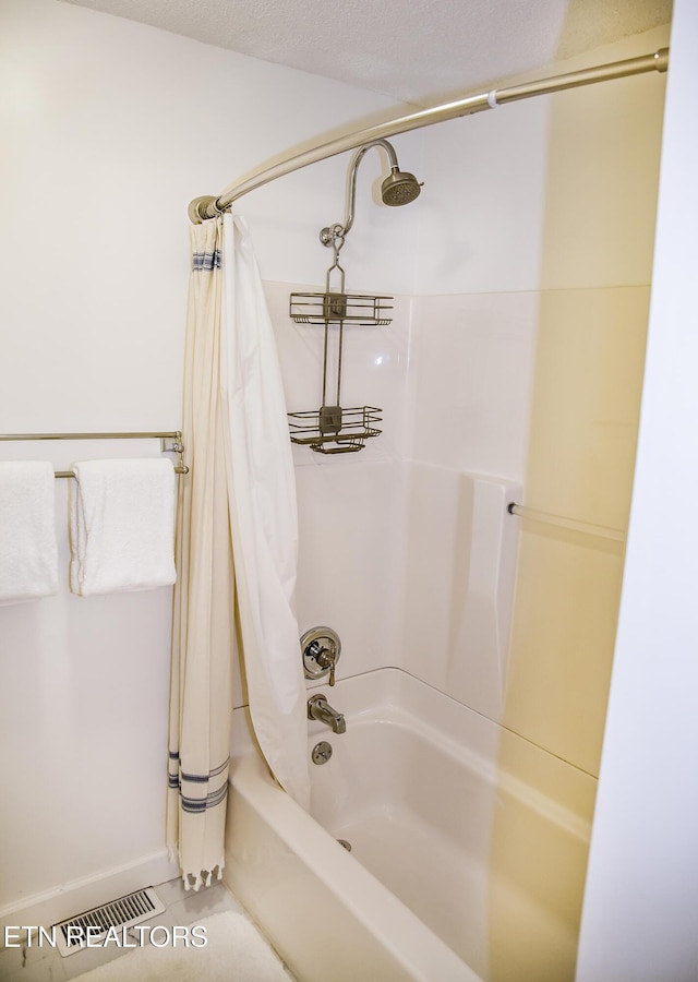 bathroom featuring tile patterned floors and shower / tub combo