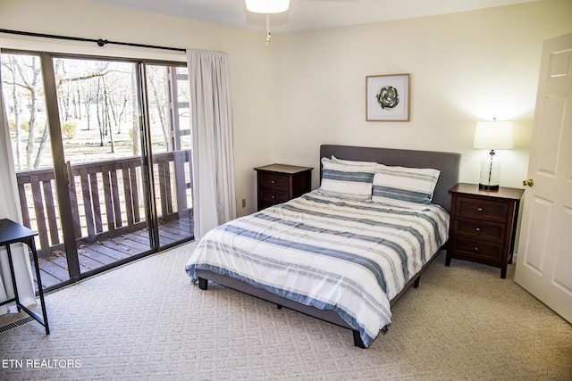 bedroom featuring light carpet and access to exterior