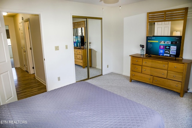 carpeted bedroom featuring a closet and ceiling fan