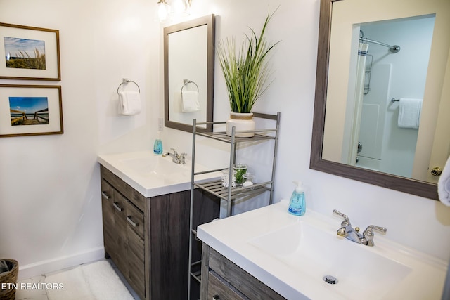 bathroom with a shower, tile patterned floors, and vanity