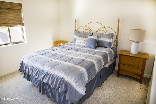 bedroom featuring light carpet