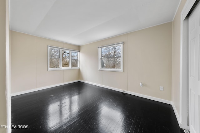 spare room with hardwood / wood-style floors