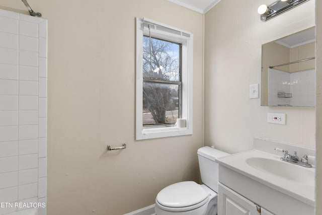 bathroom featuring toilet, vanity, ornamental molding, and walk in shower