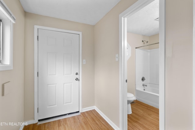 foyer entrance featuring hardwood / wood-style flooring and a textured ceiling