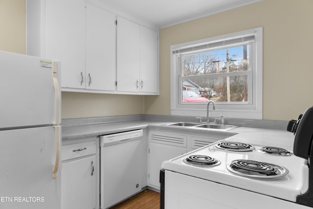 kitchen with light hardwood / wood-style floors, sink, white appliances, and white cabinets