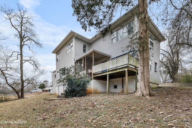 back of house with a wooden deck