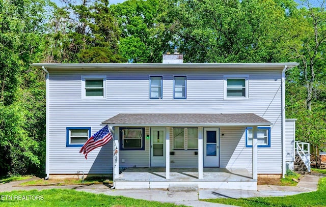 view of front of house with a porch and a chimney
