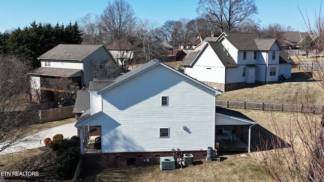 back of house with a yard and central AC unit