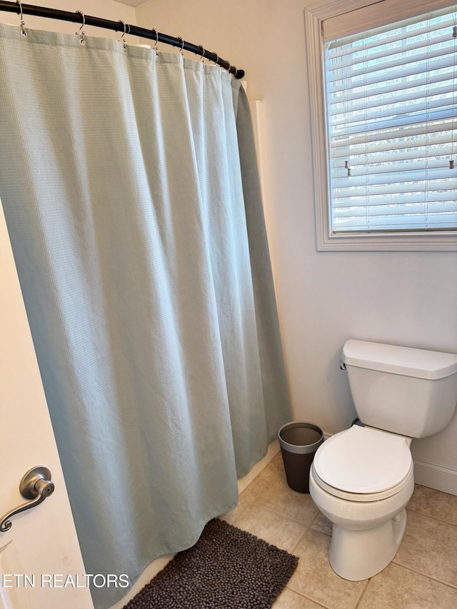 bathroom with tile patterned floors and toilet